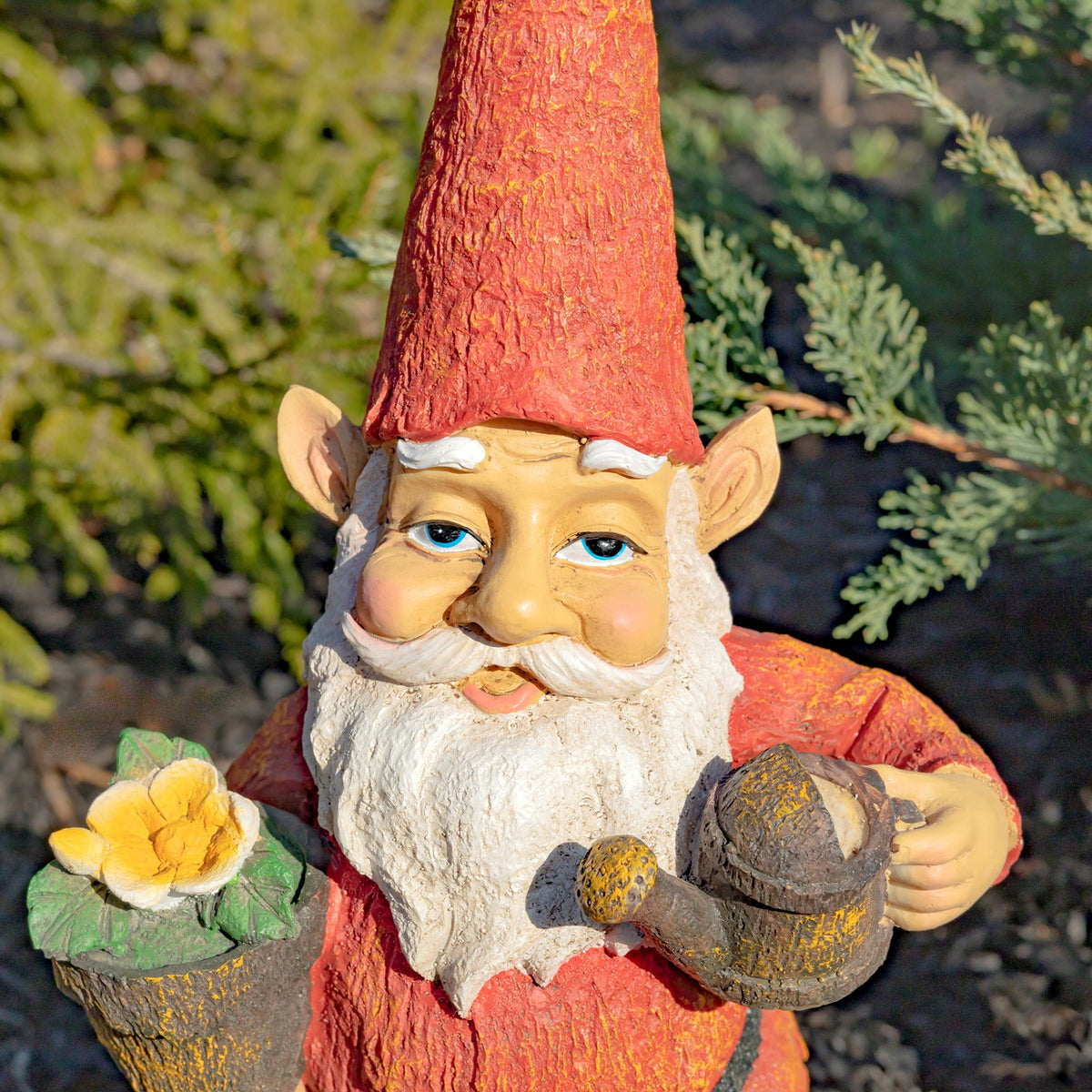 Close-up of the gnome’s face, white beard, yellow flower pot, and watering can.
