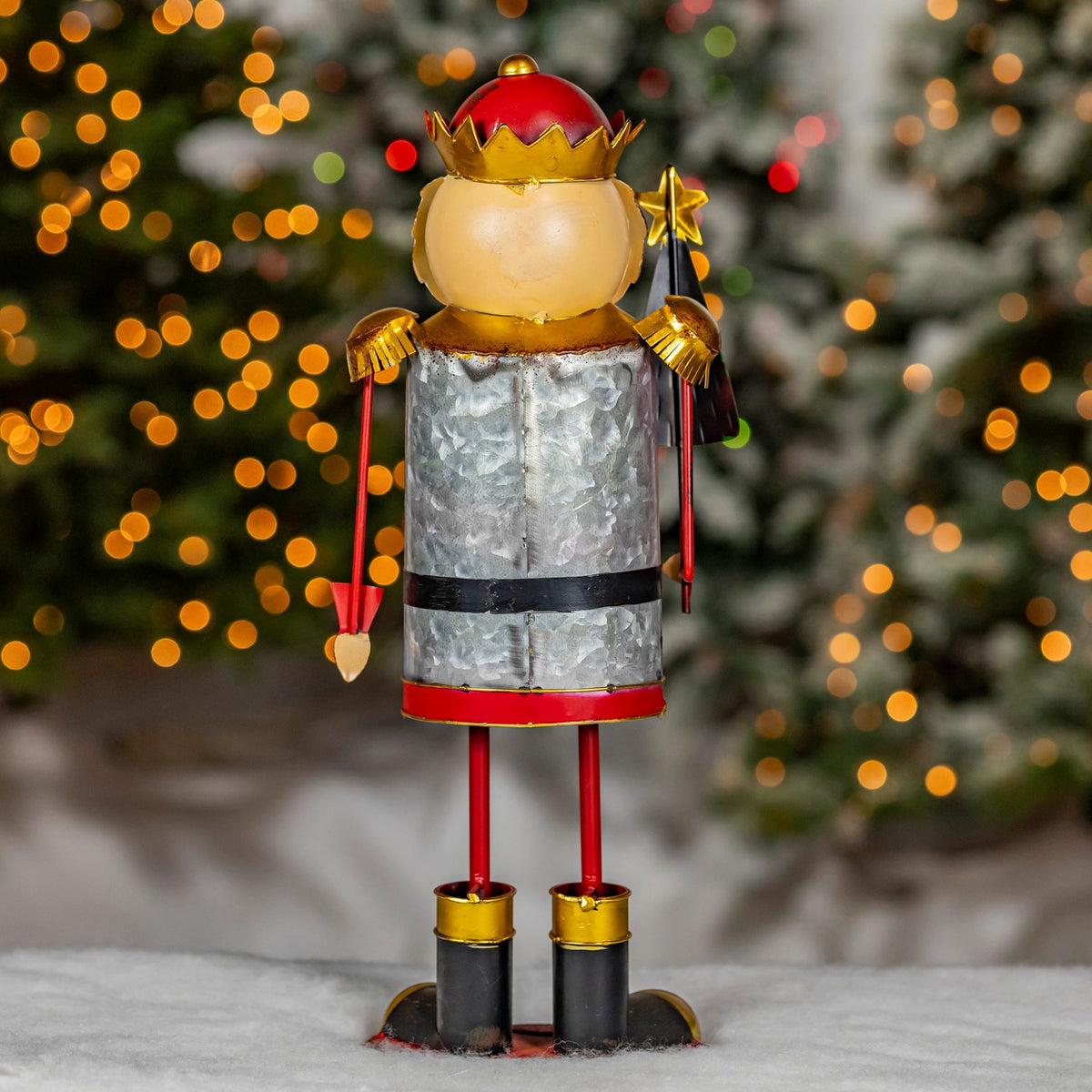 Rear view of the nutcracker figurine showing its silver back and red legs