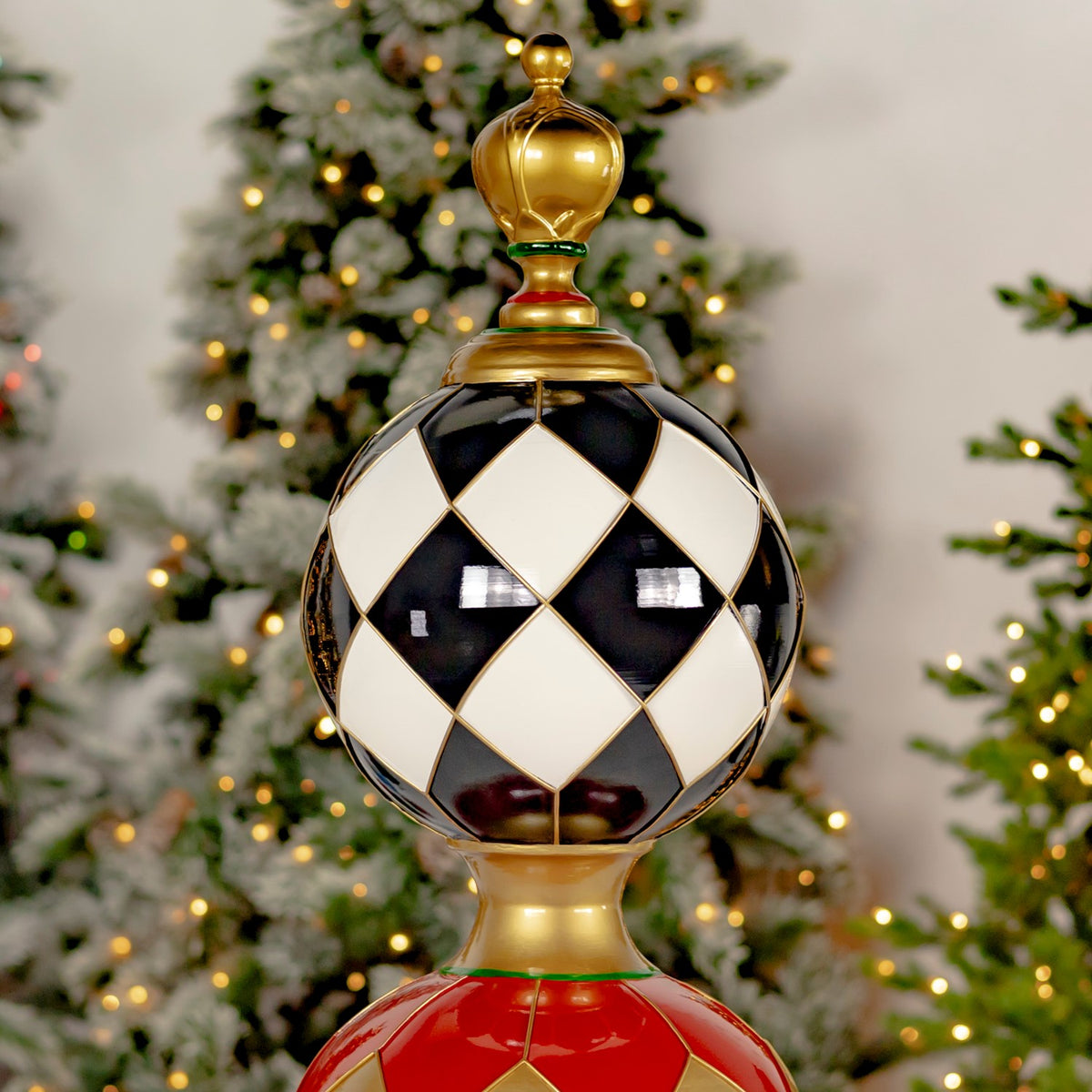 Close-up of the tower’s glossy black-and-cream diamond-patterned sphere and gold-colored finial.
