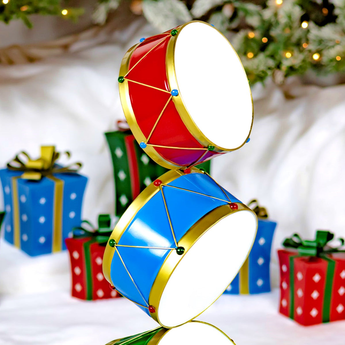 Close view of the tower’s red and blue drums, with gold rims, crisscross cords, and bright studs.