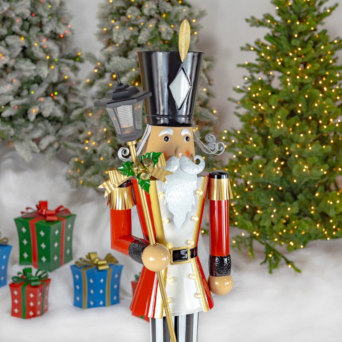 Three-quarter view highlighting the nutcracker’s curled mustache, gold-trimmed coat and lantern.