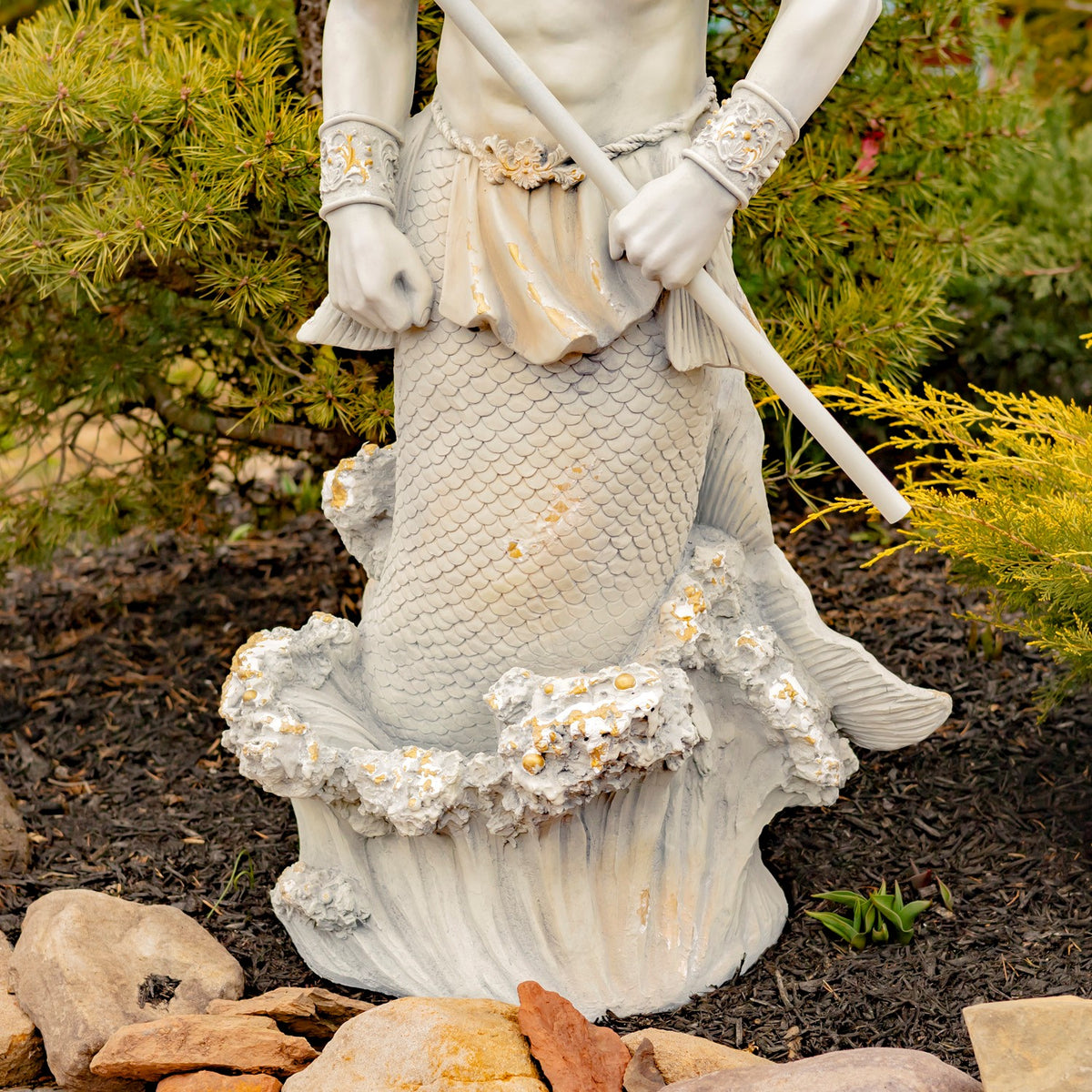 Close view of the scaled fish tail and sculpted wave base with scattered gold-toned accents.