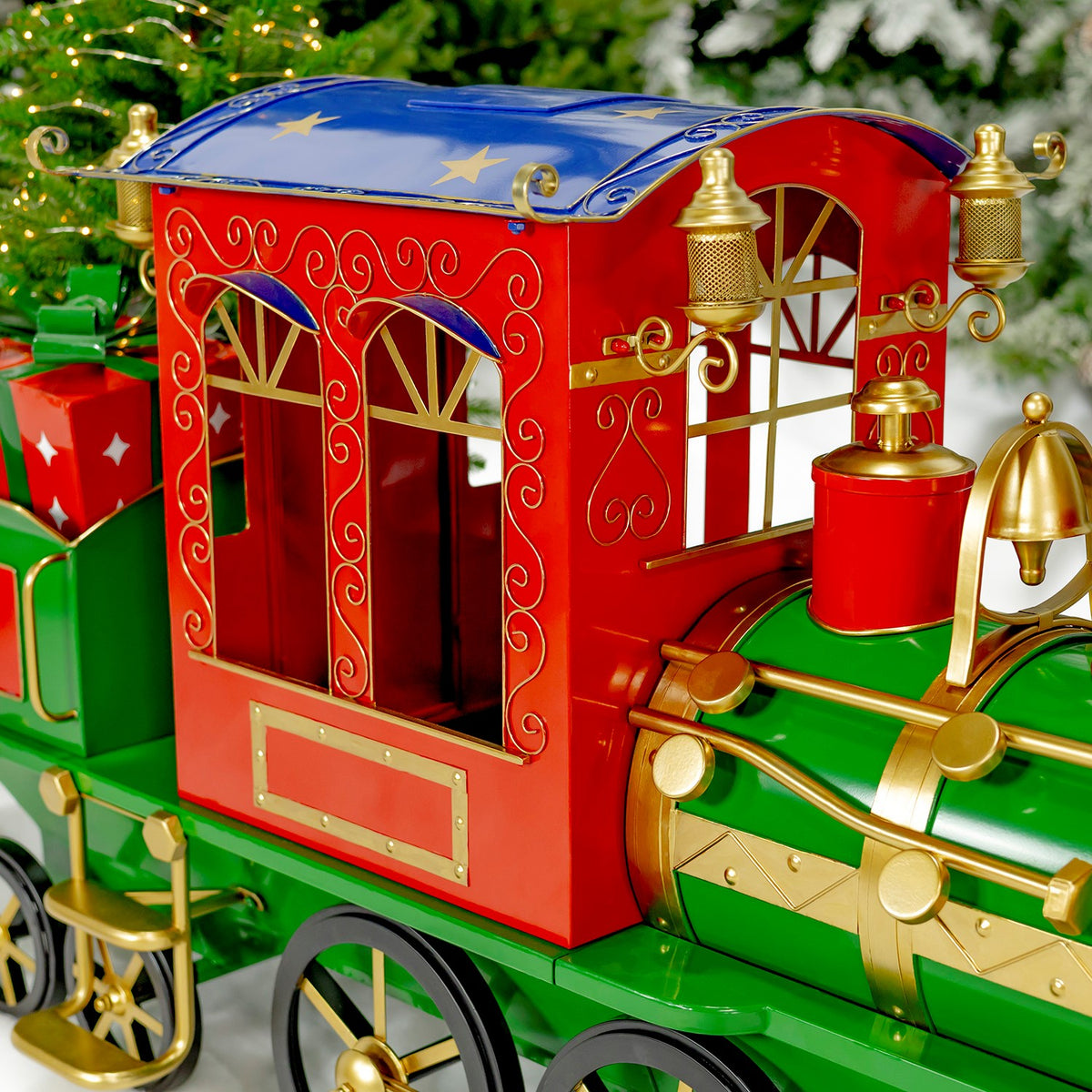 Close-up of the red carriage with arched windows, a blue star-patterned roof and gold decorative trim.