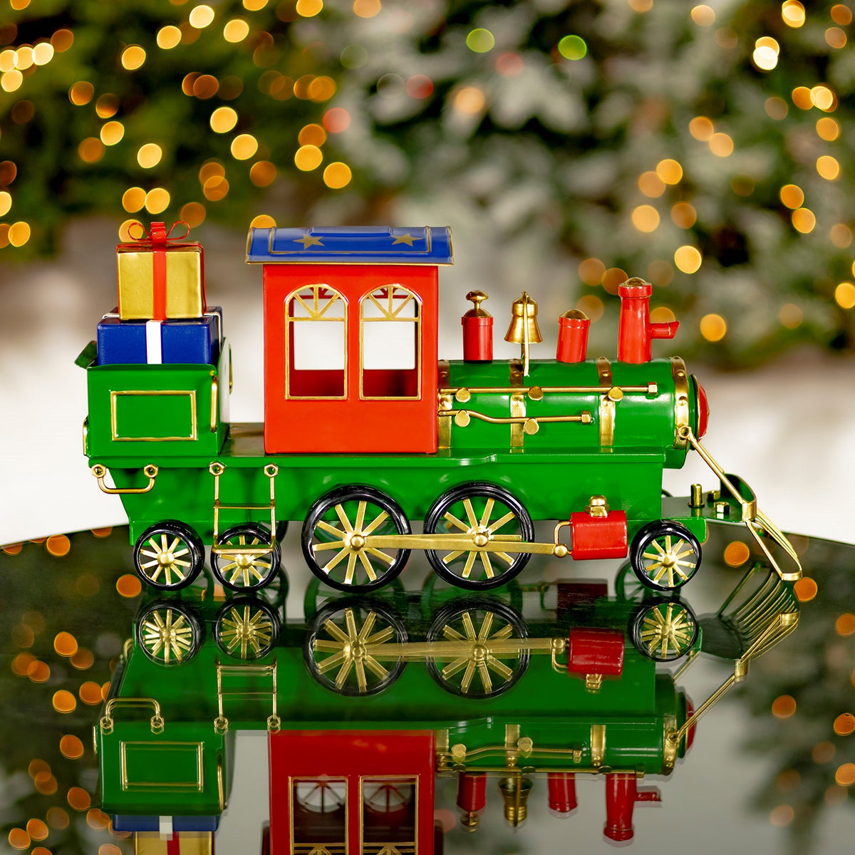 Side view of a green and red Christmas train with gifts and a starry roof