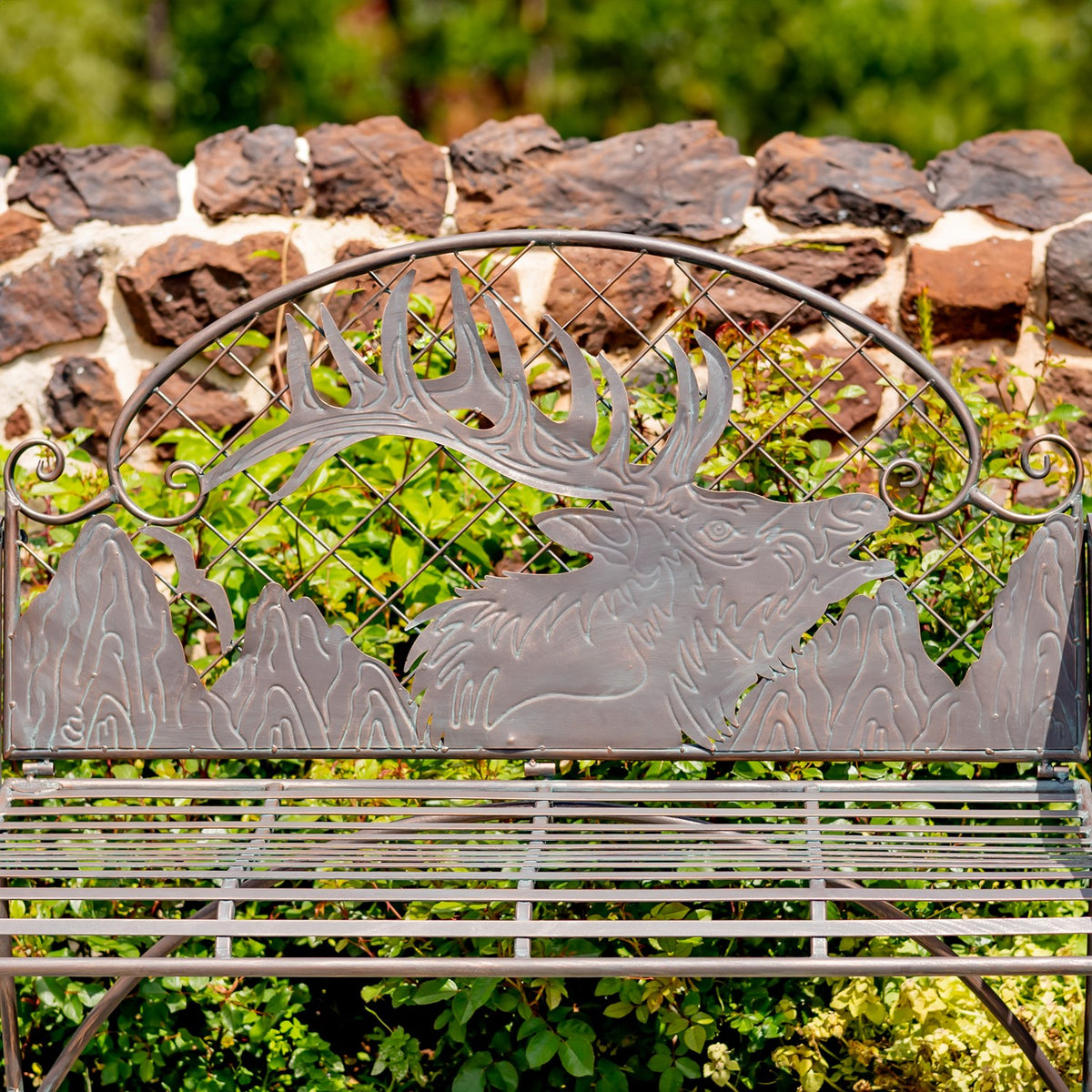 Closer view of the bench backrest with a caribou design, antlers, and diamond-pattern metalwork