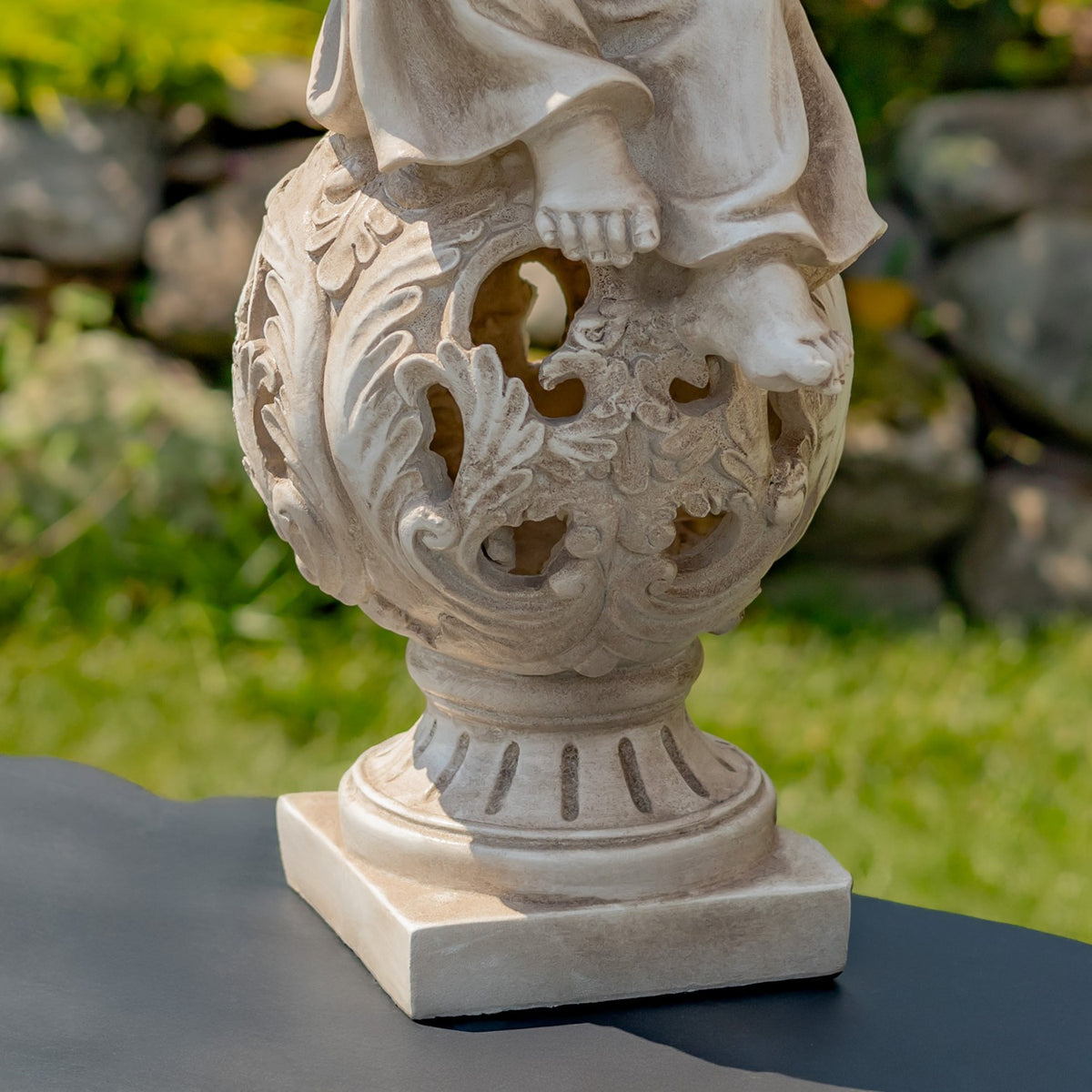 Close view of the statue's ornate openwork pedestal and square base