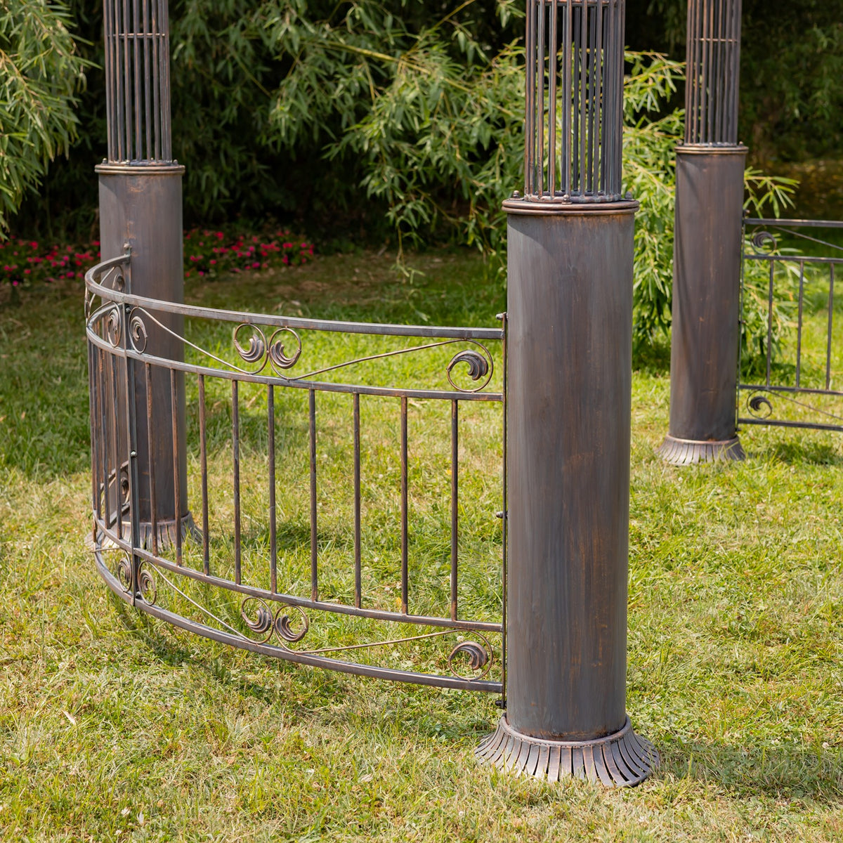 Close view of the gazebo’s curved iron railing, scrollwork, and fluted post bases