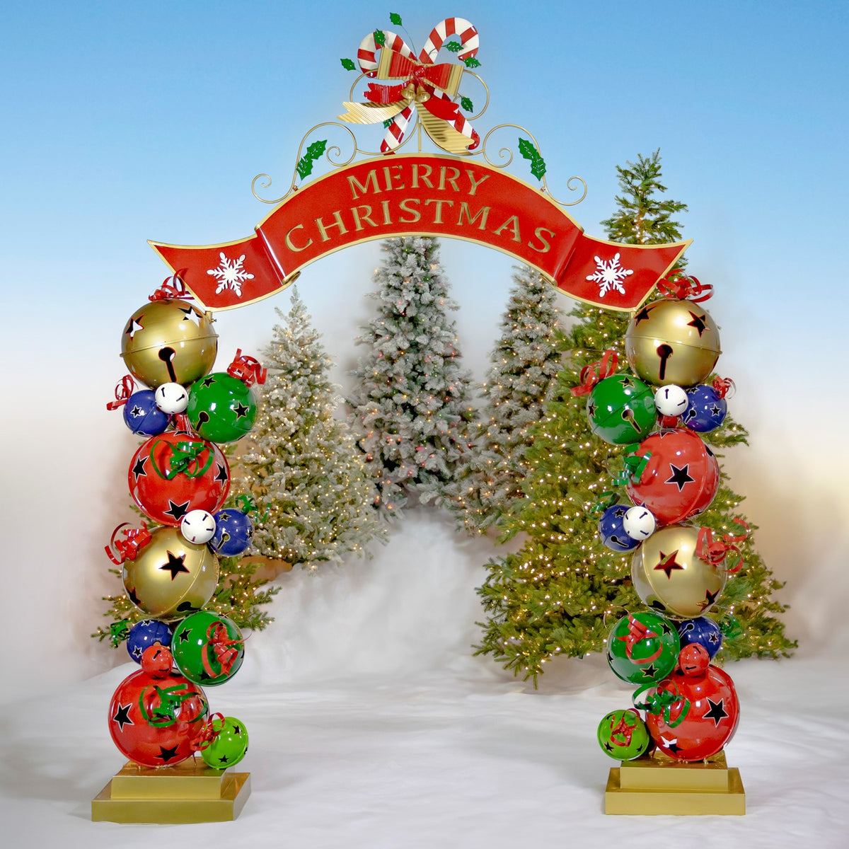 Front view of the Christmas archway framed by snowy holiday trees