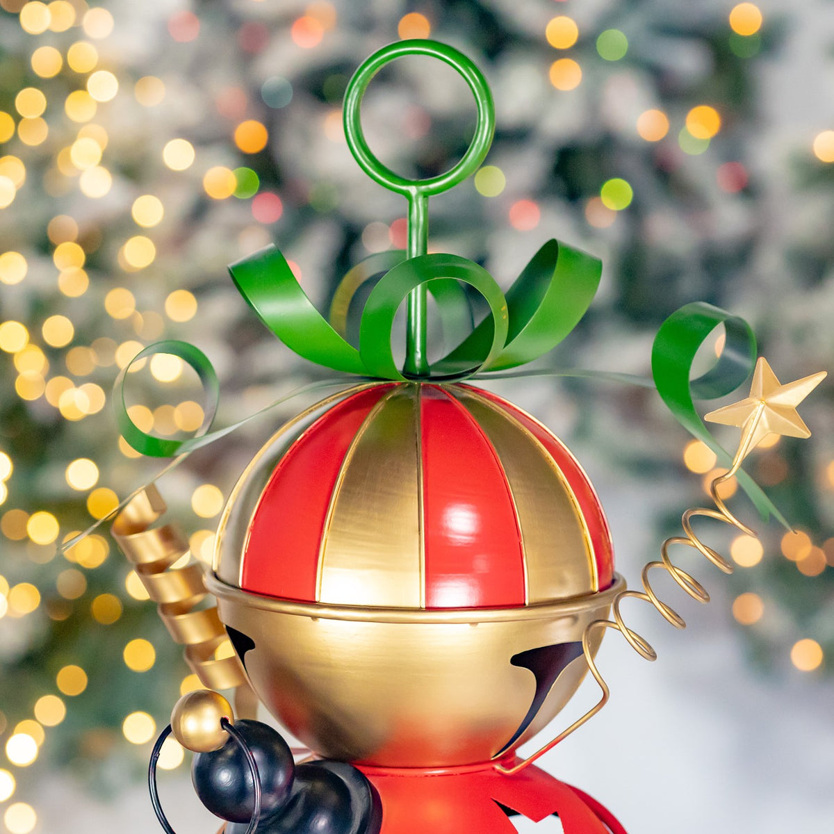 Close-up of a red-and-gold dome topped with a green ring and curled decorations.