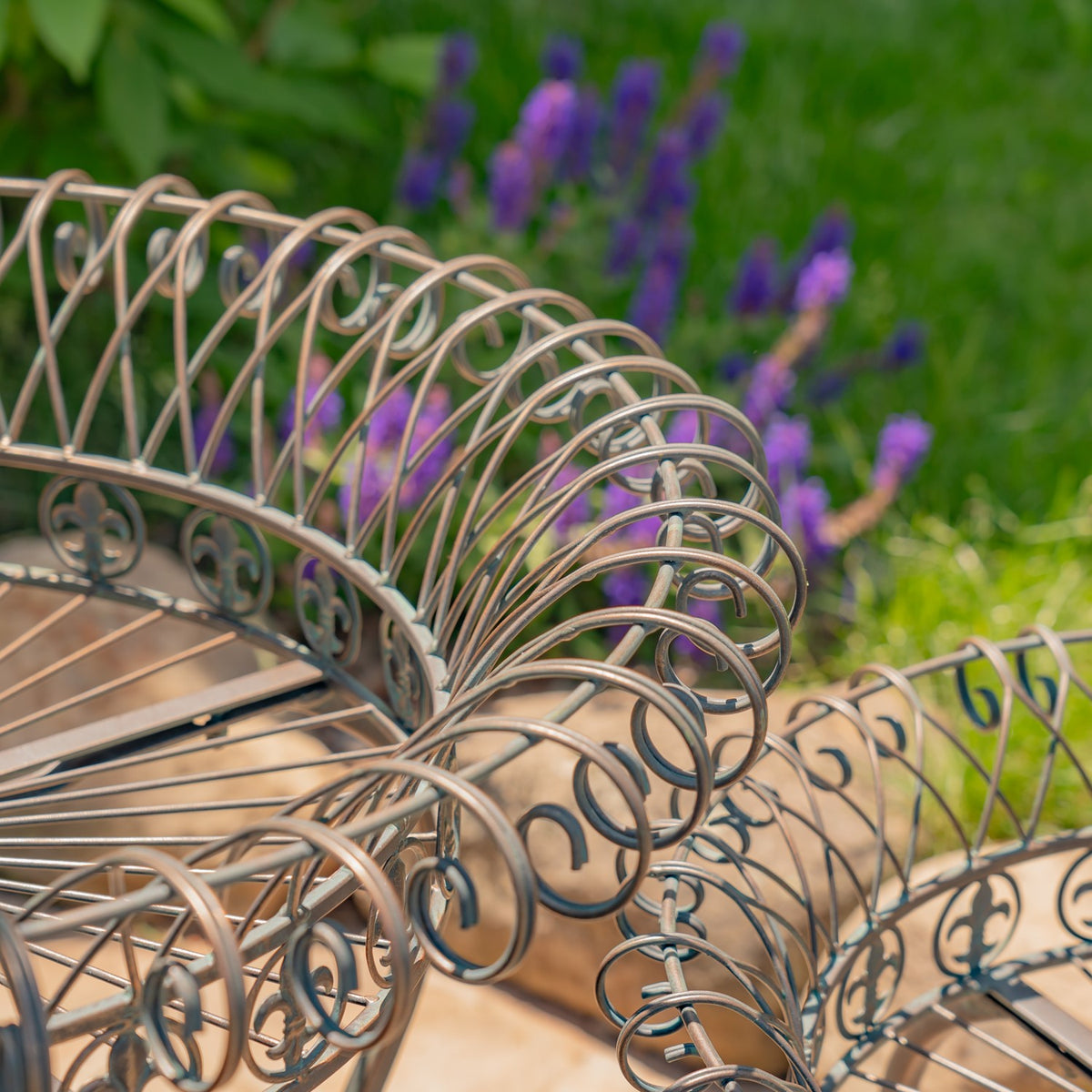 Close-up of the stands’ curled wire basket rims and decorative scrollwork.