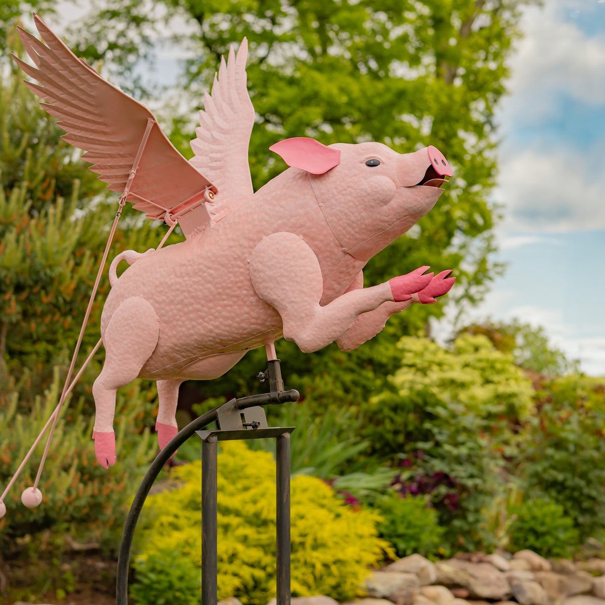 Close angled view of the pink flying pig and its raised wings