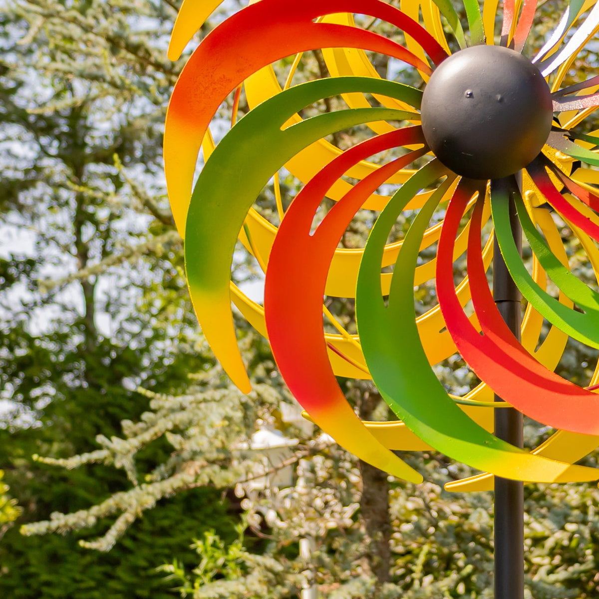 Close view of overlapping red, green, and yellow blades and the rounded dark hub.