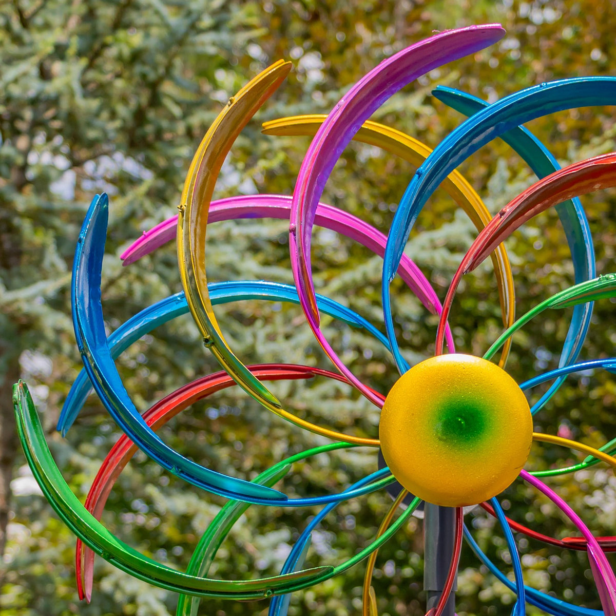 Close-up of curved multicolored metal blades and the windmill's center