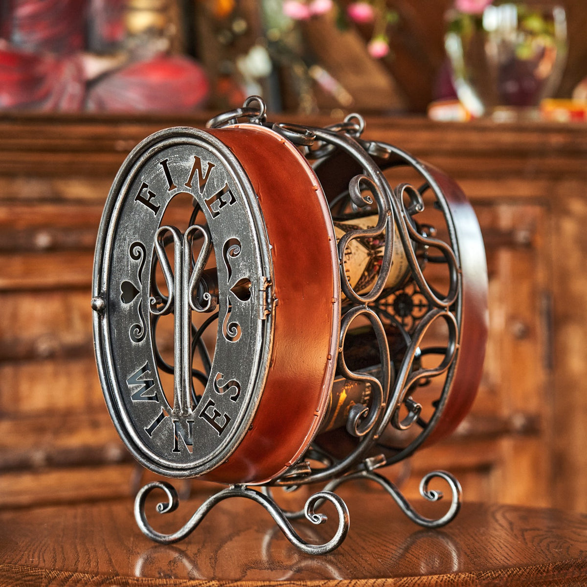 Close angled view of the oval rack's metal end panel, curved sides, and scrollwork supports.