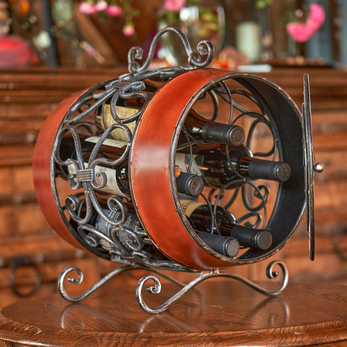 View through the open end of the barrel-shaped rack, with several wine bottles held horizontally inside.