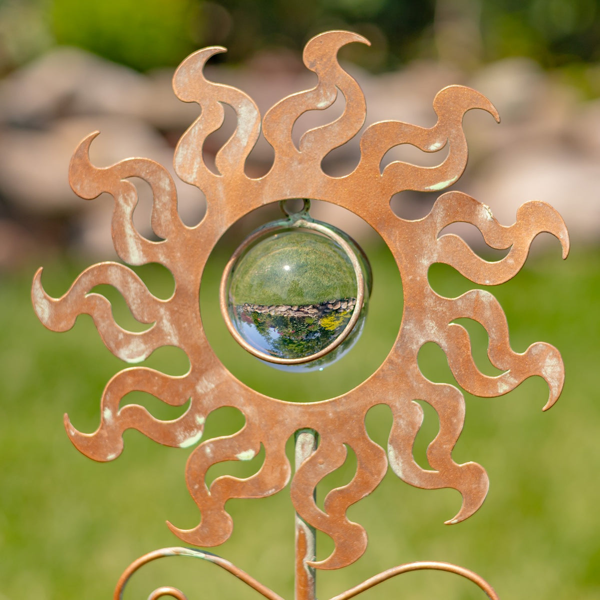 Close-up of the wavy sun rays surrounding a reflective glass center.