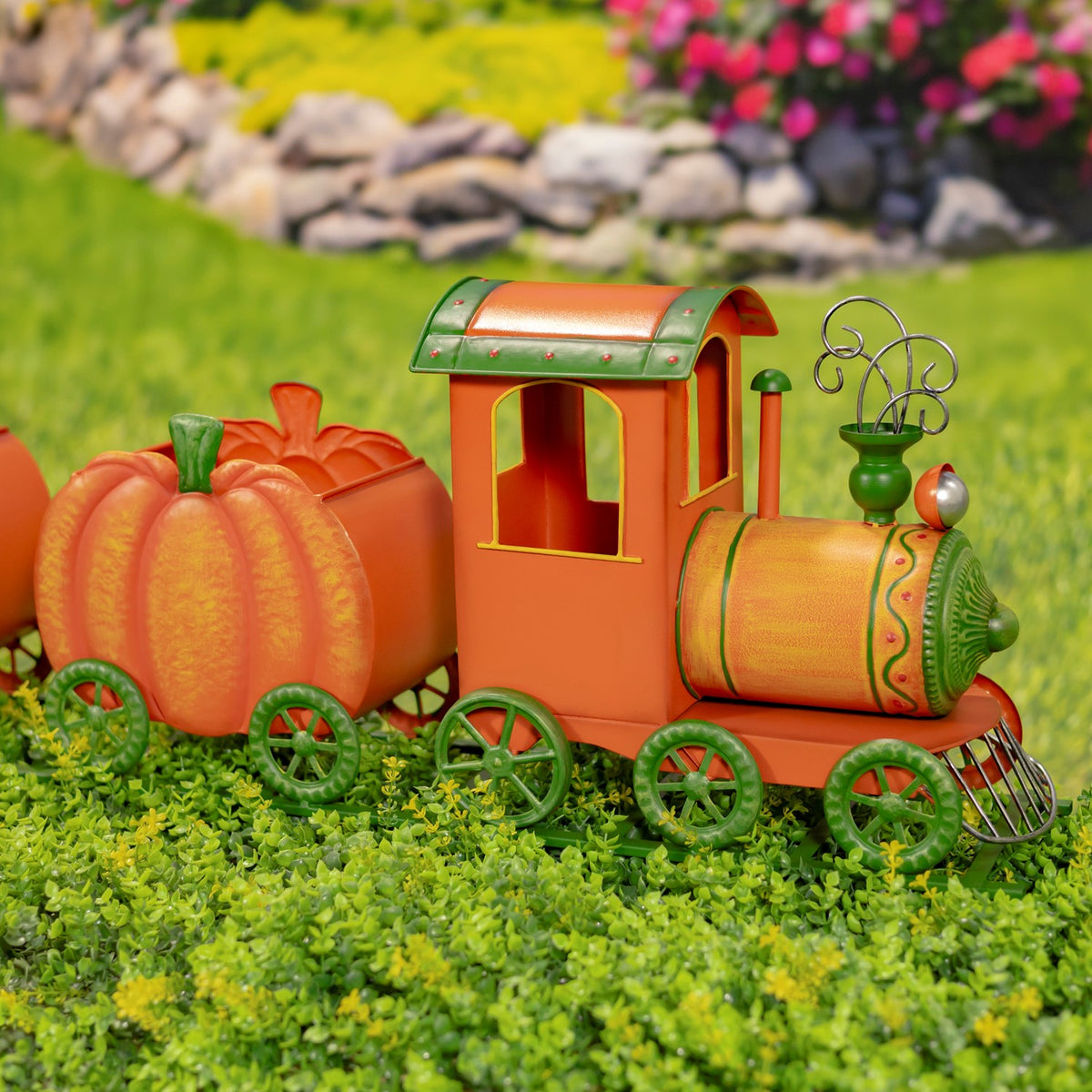 Pumpkin train viewed from the other side, with the engine facing right and pumpkin carts trailing behind.