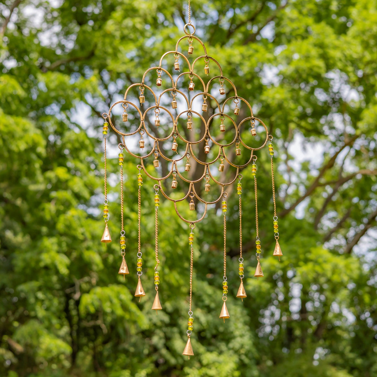 Hanging gold metal chime with a diamond arrangement of rings and colorful beaded strands.