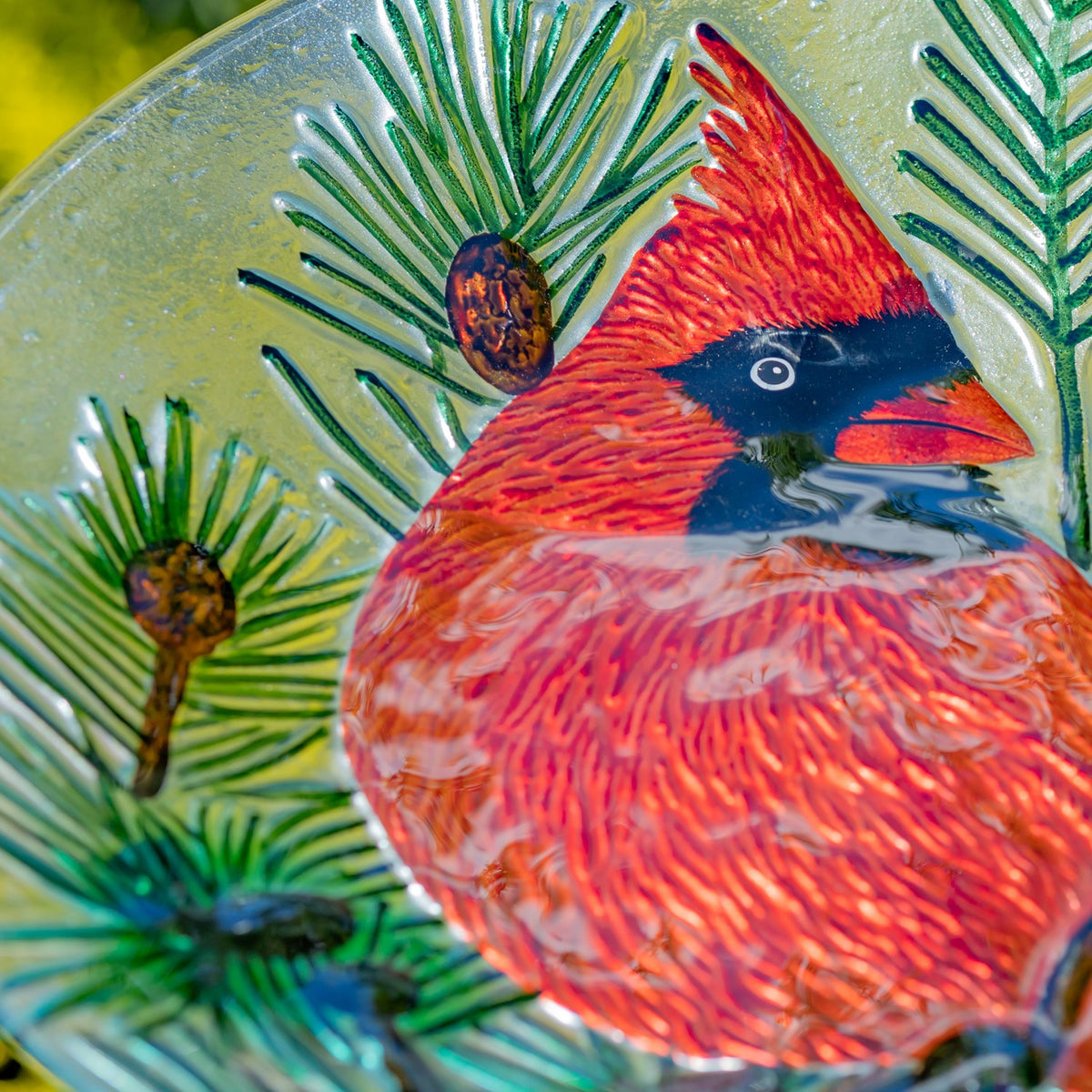 Close-up of the hand-painted red cardinal and evergreen branches on the glass bowl