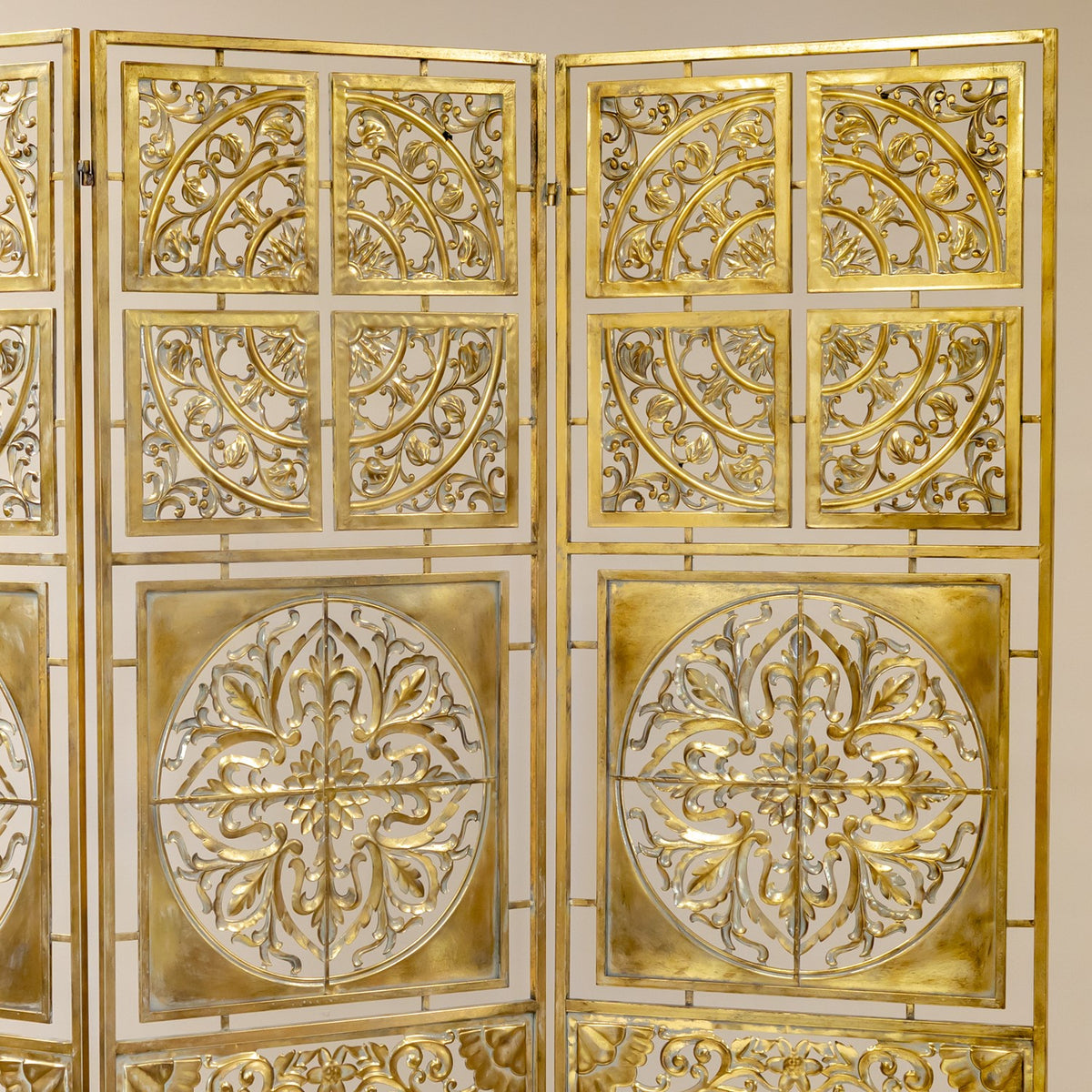 Upper sections of the gold screen show circular scrollwork and large floral motifs across the panels.