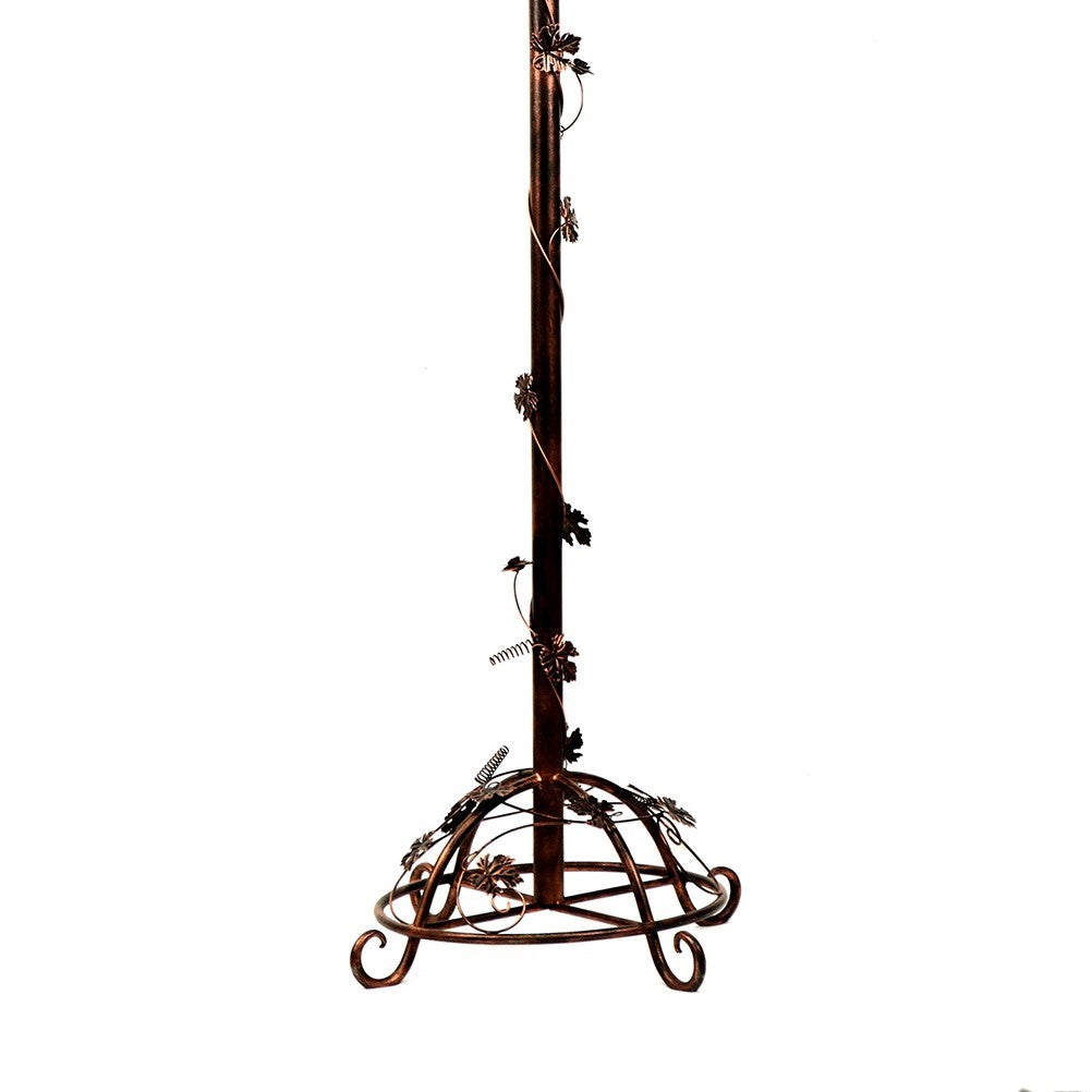 Antique bronze circular base with curled feet, decorative metalwork and a central stem.