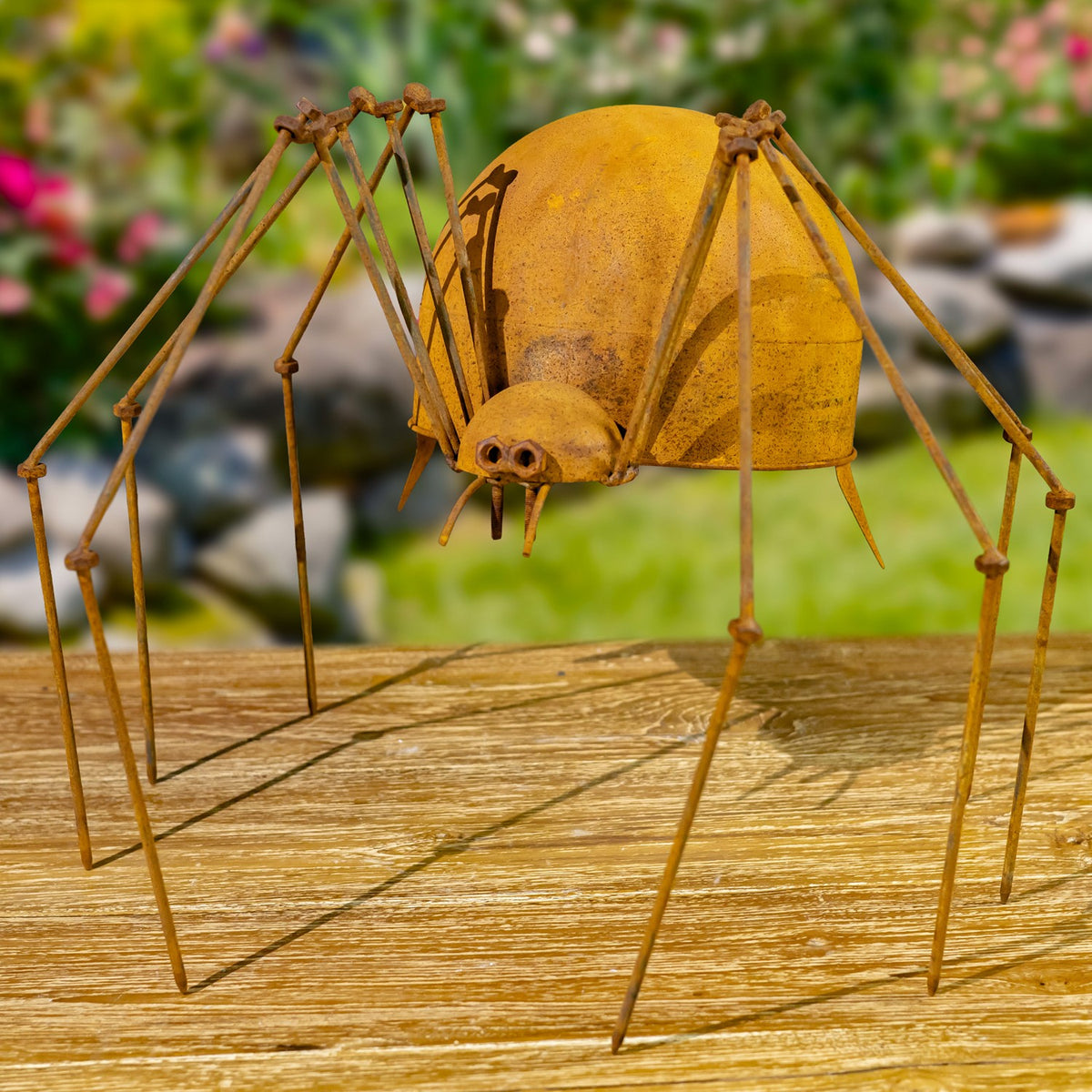 Close view of a rust-finish iron spider figurine with long legs