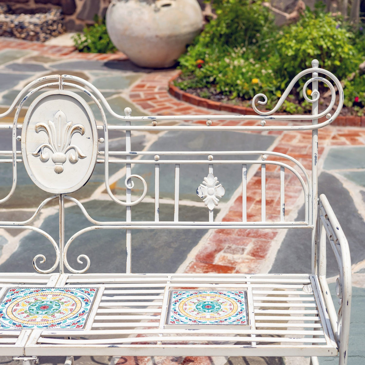 Decorative oval back medallion and floral accents above patterned mosaic seat tiles