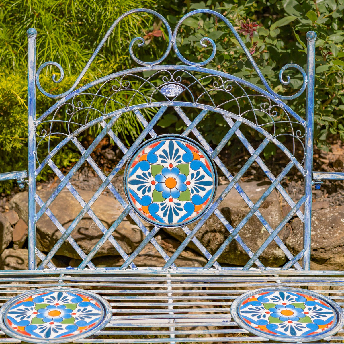 Close view of the bench’s lattice backrest and bright floral mosaic inlays.