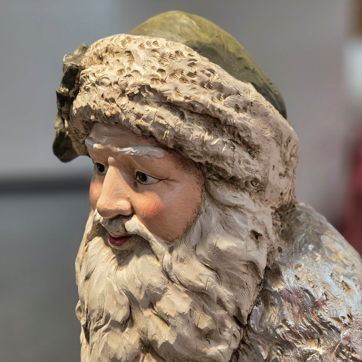 Close-up of Santa's painted face, beard and textured hat