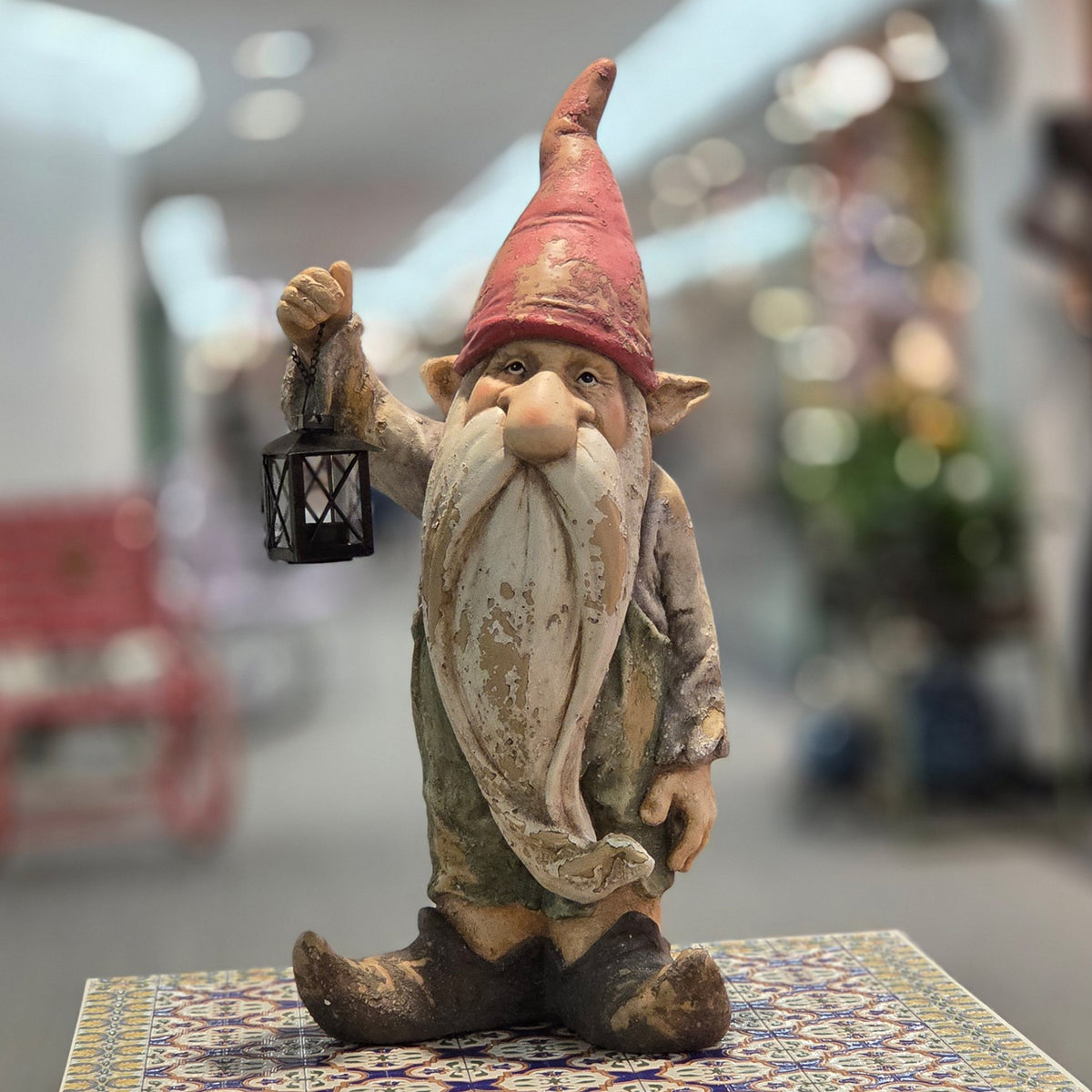 Front view of a bearded garden gnome in a red pointed hat