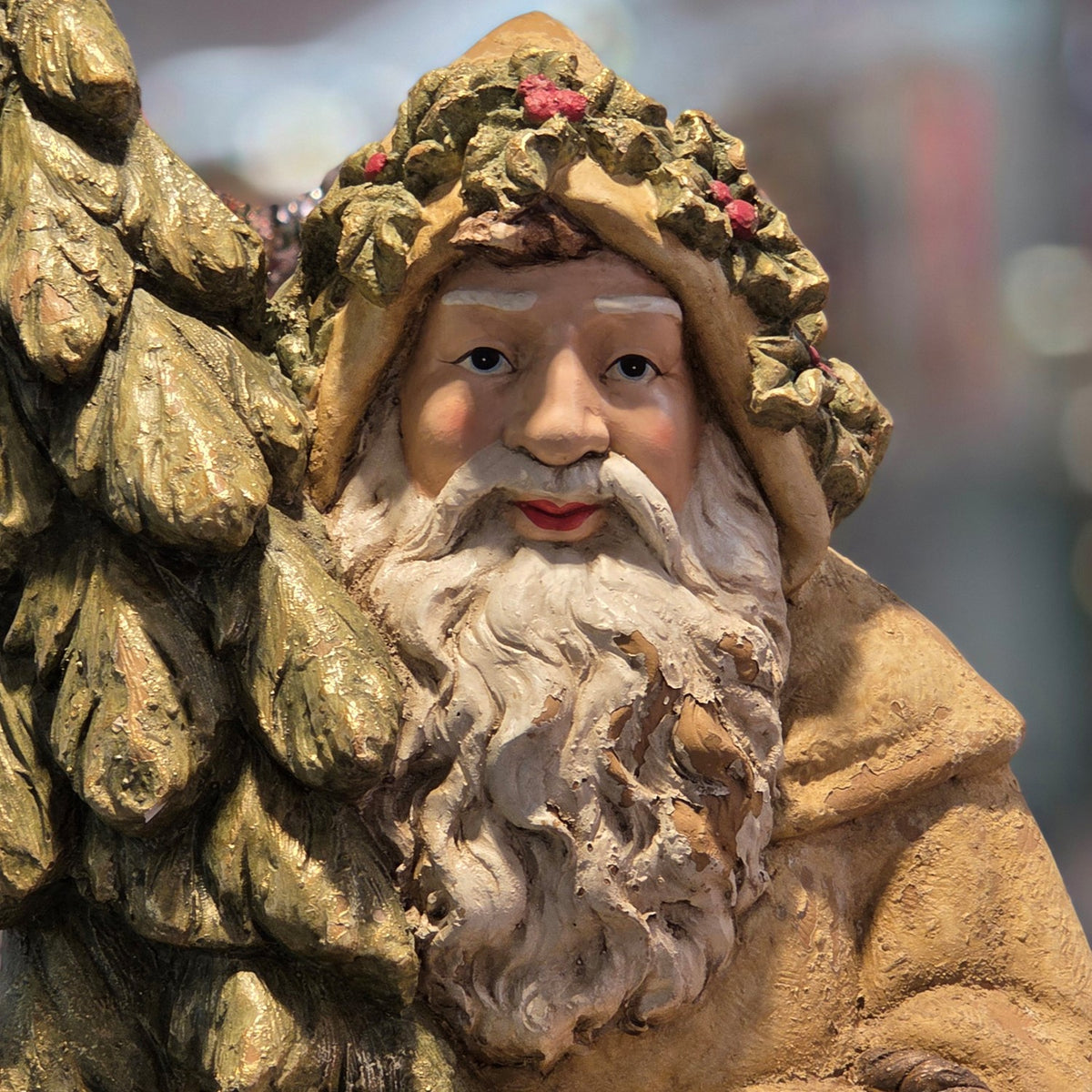 Close-up of Santa's face, white beard, floral hood, and evergreen tree