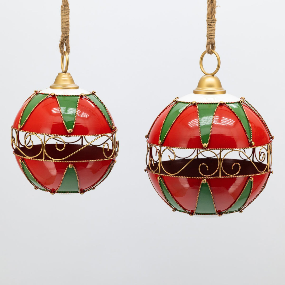 Two red, green, and white ornaments show glossy panels and ornate gold bands.