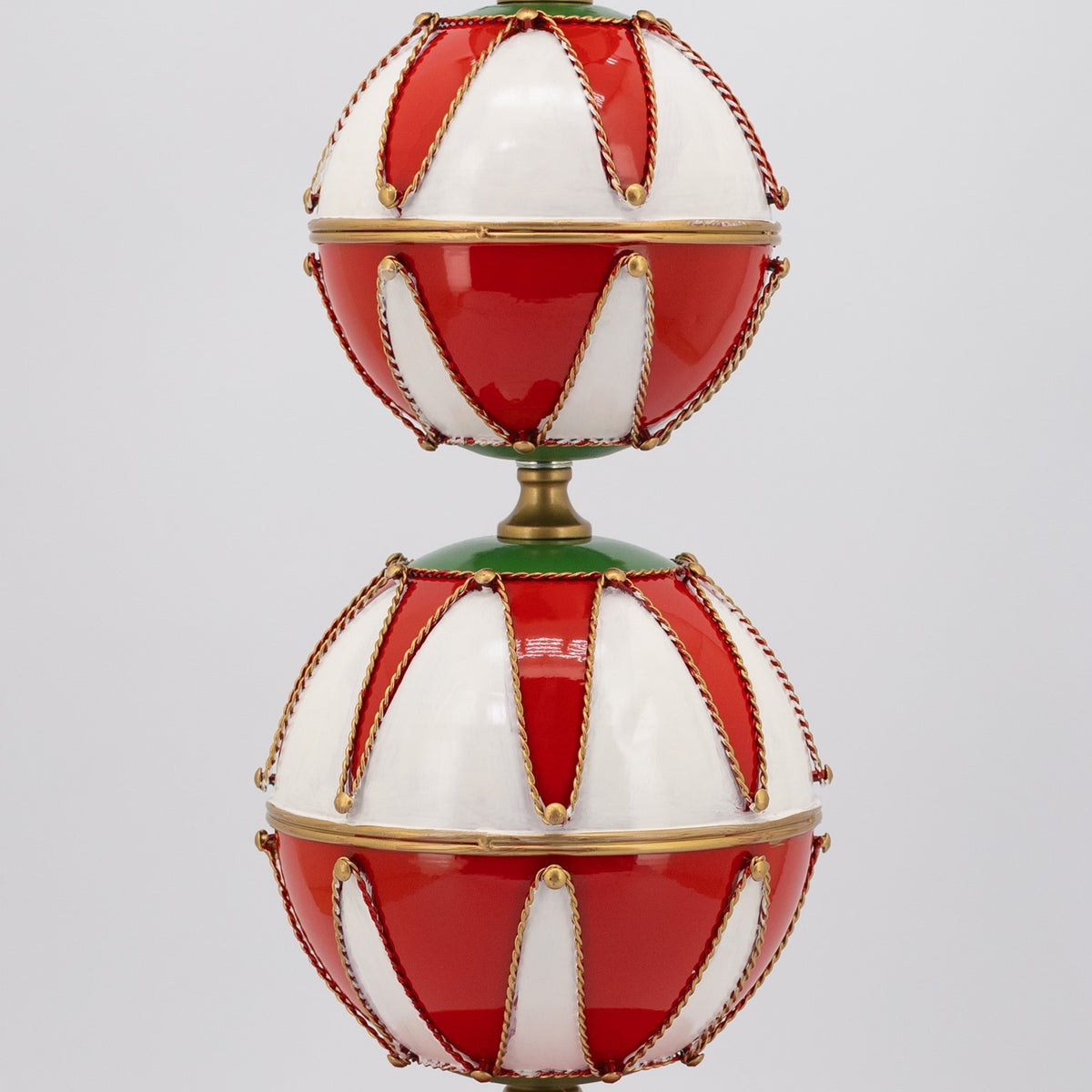 Two stacked red-and-white baubles with gold edging and decorative cords.