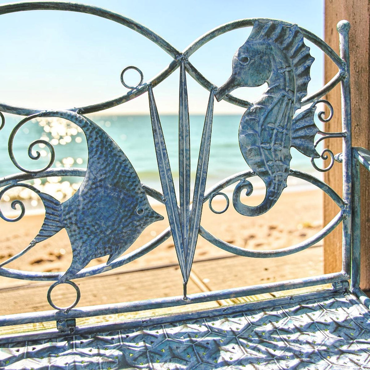 Close view of the seahorse and fish details on the blue iron backrest