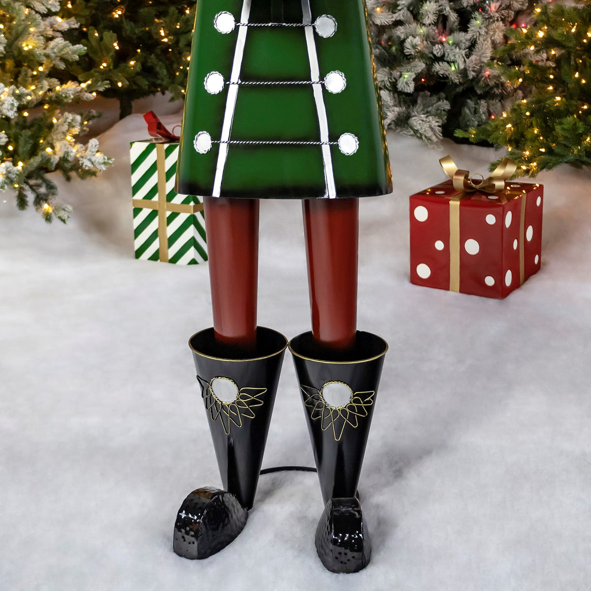 Close view of the nutcracker's green coat, red legs and black boots