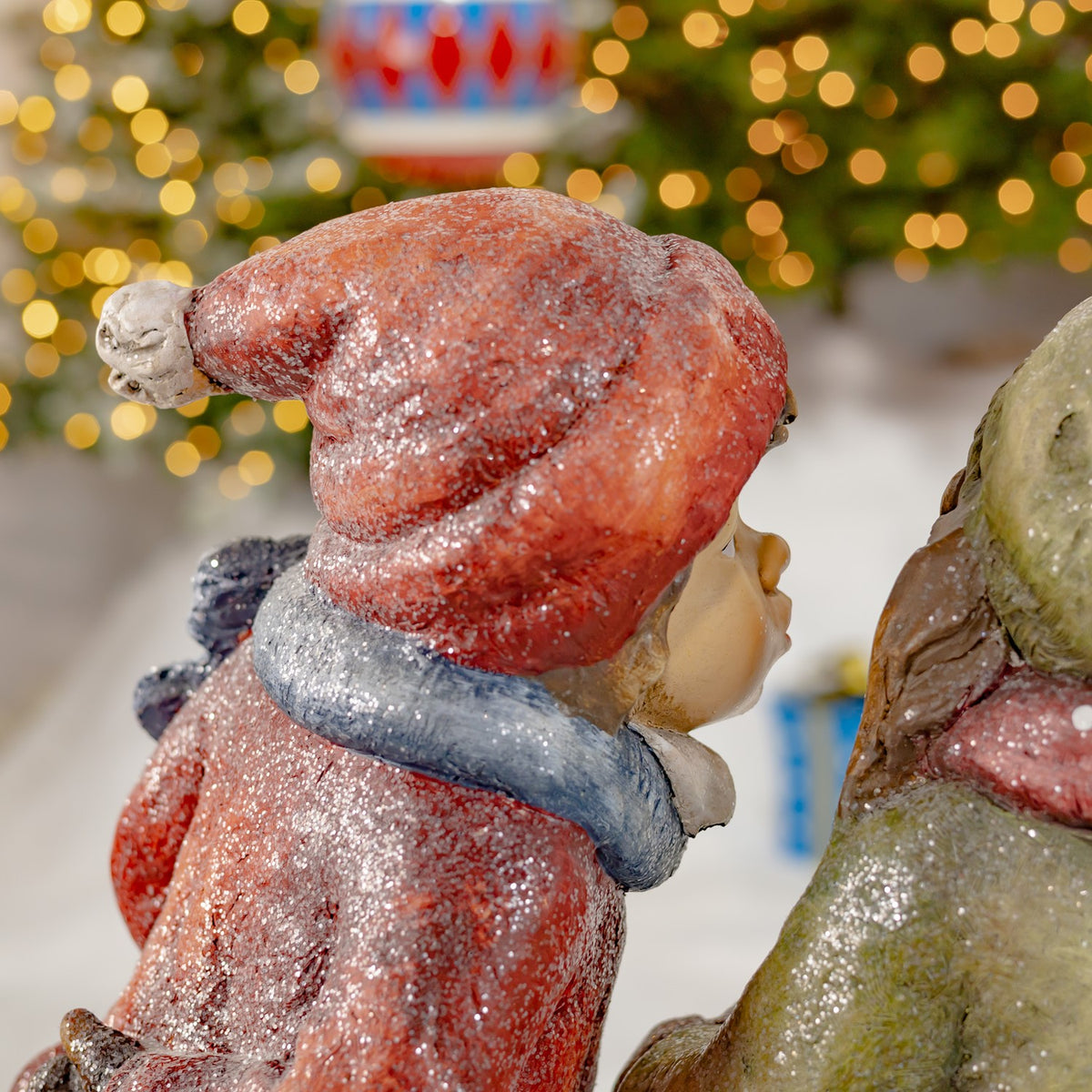 Side and rear view of the boy figurine beside the girl