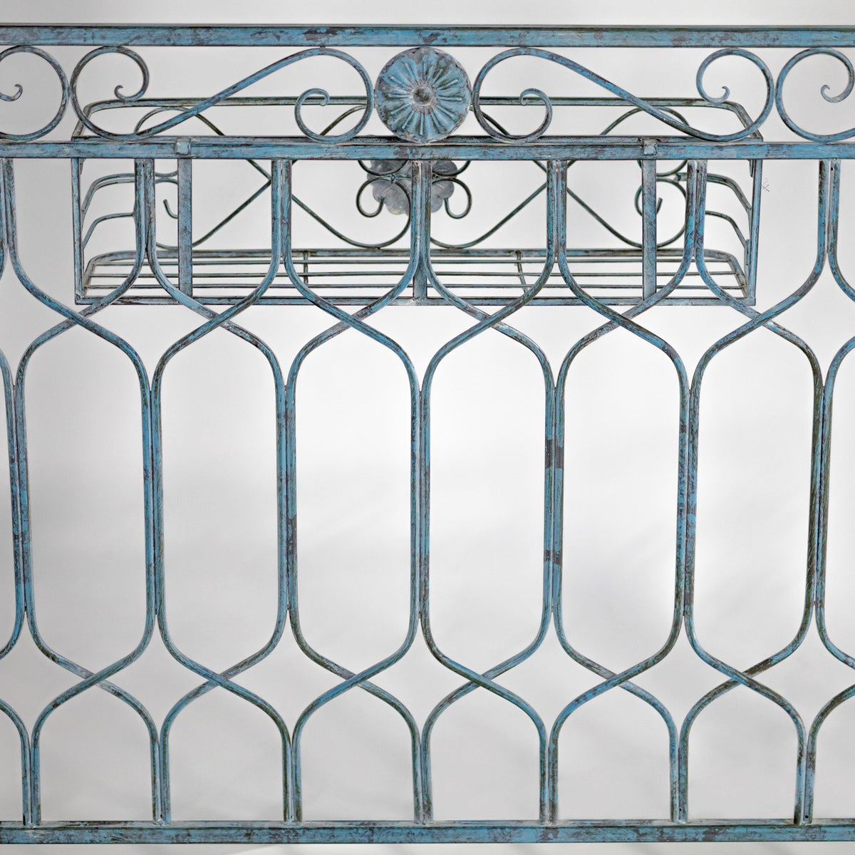 Close-up of blue iron gazebo side fencing with ornate decorative metalwork