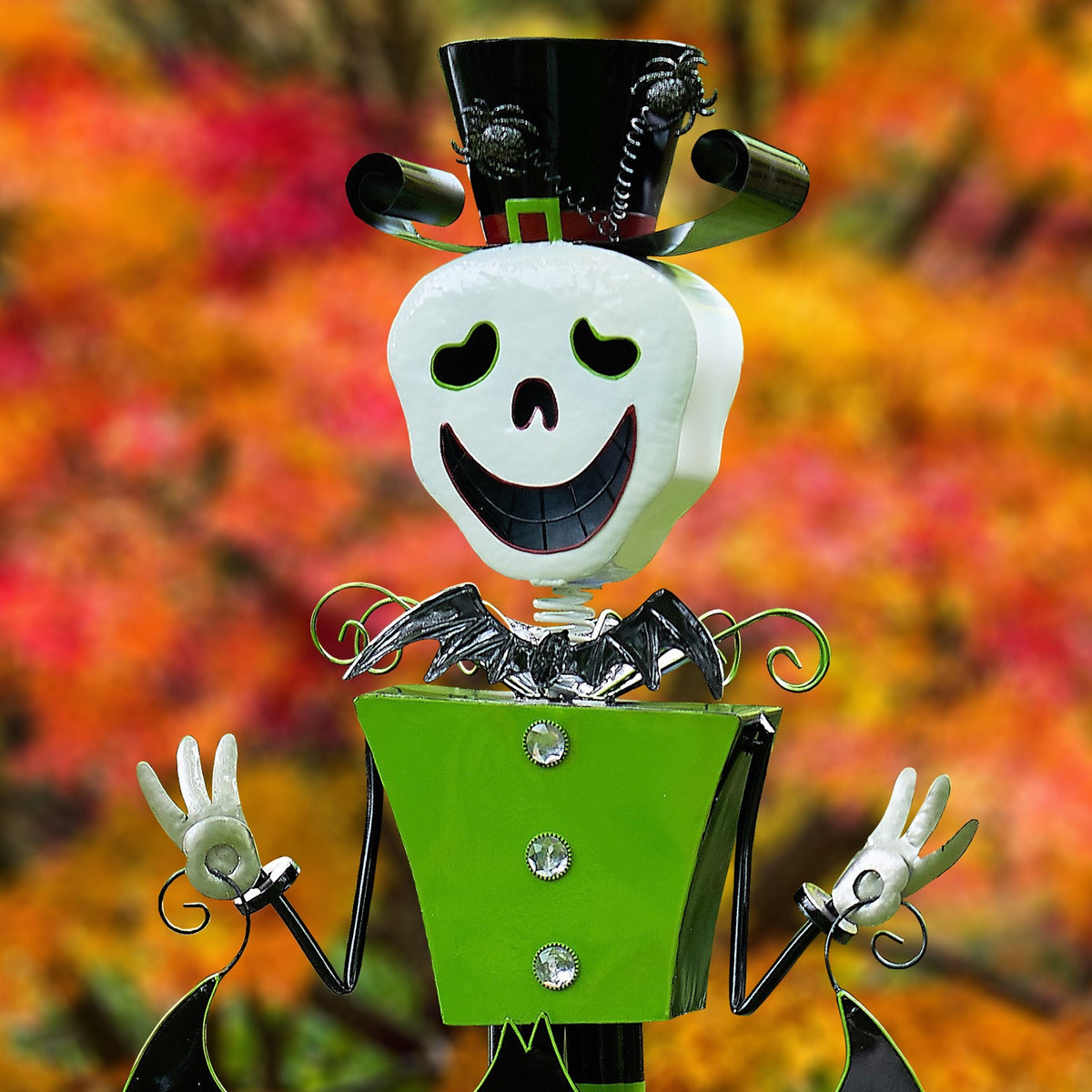Close-up of the skeleton’s smiling face, top hat, green coat with shiny buttons, and raised hands.