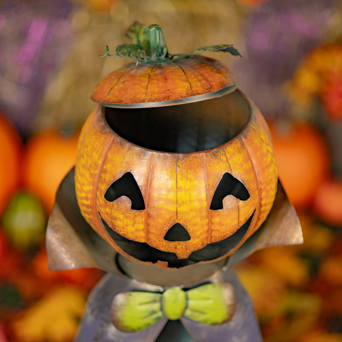 Pumpkin head lid lifted to reveal the dark candy dish inside