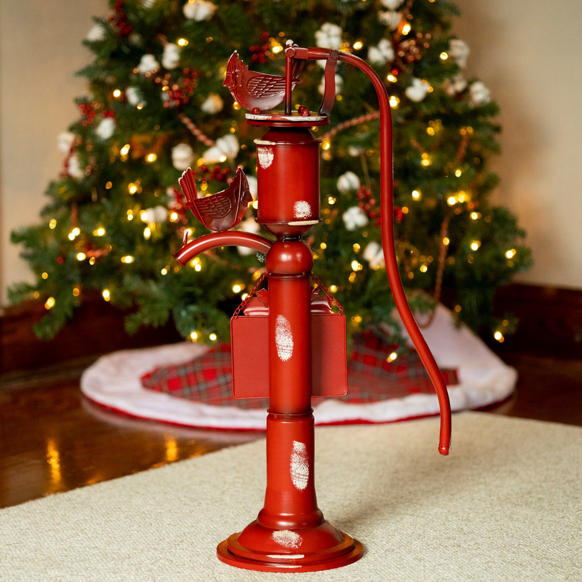 Back of the red water pump decoration, with two brown bird ornaments and the reverse of its hanging sign.