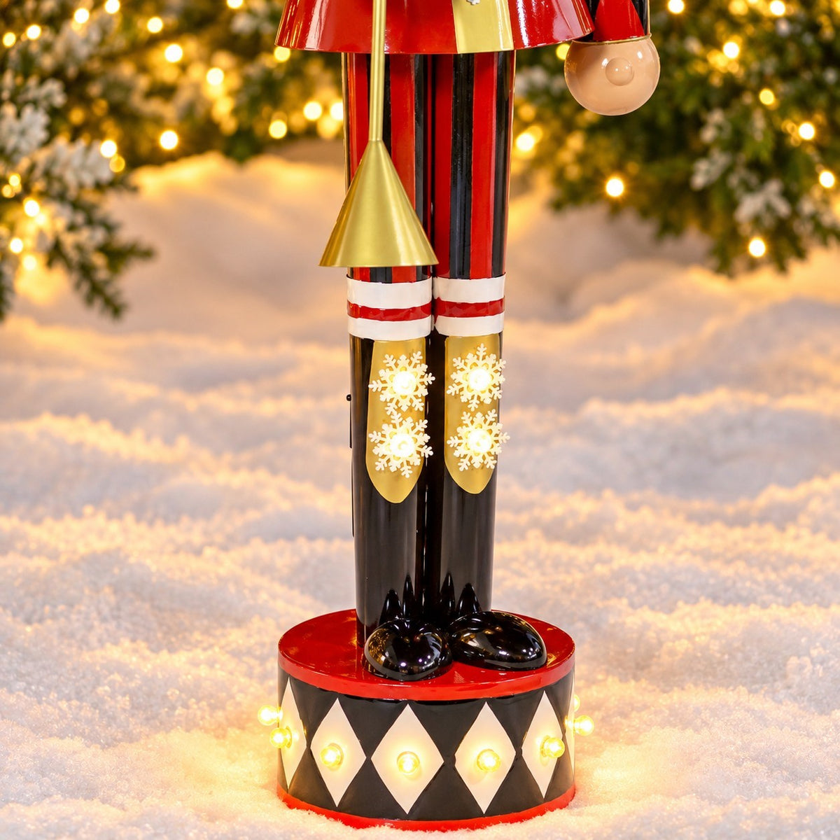 Close-up of striped trousers, gold boot decorations, black shoes, and the illuminated display base.
