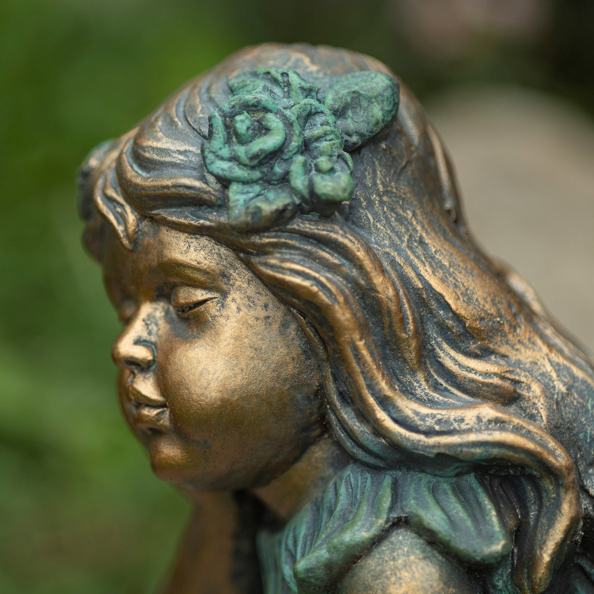 Close view of the fairy’s wavy hair and sculpted flower decoration.