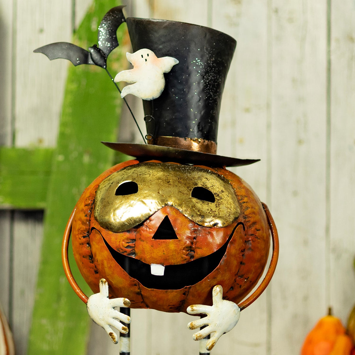 Upper view of the pumpkin figurine with a black top hat and white hands