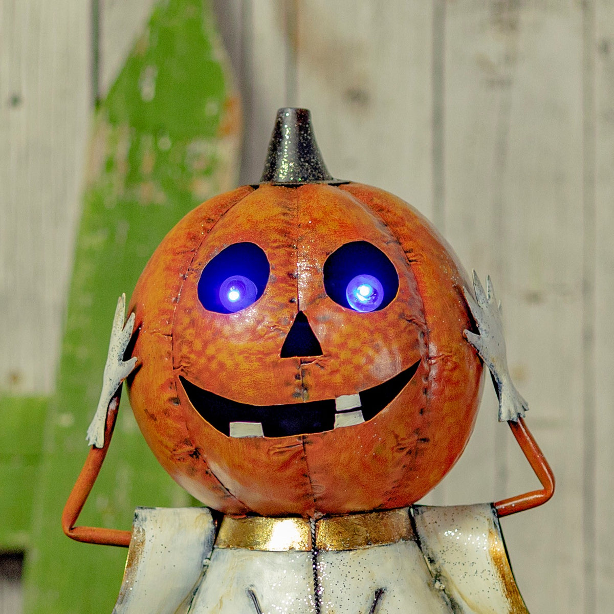 Close-up of the orange jack-o'-lantern face with bright purple LED eyes