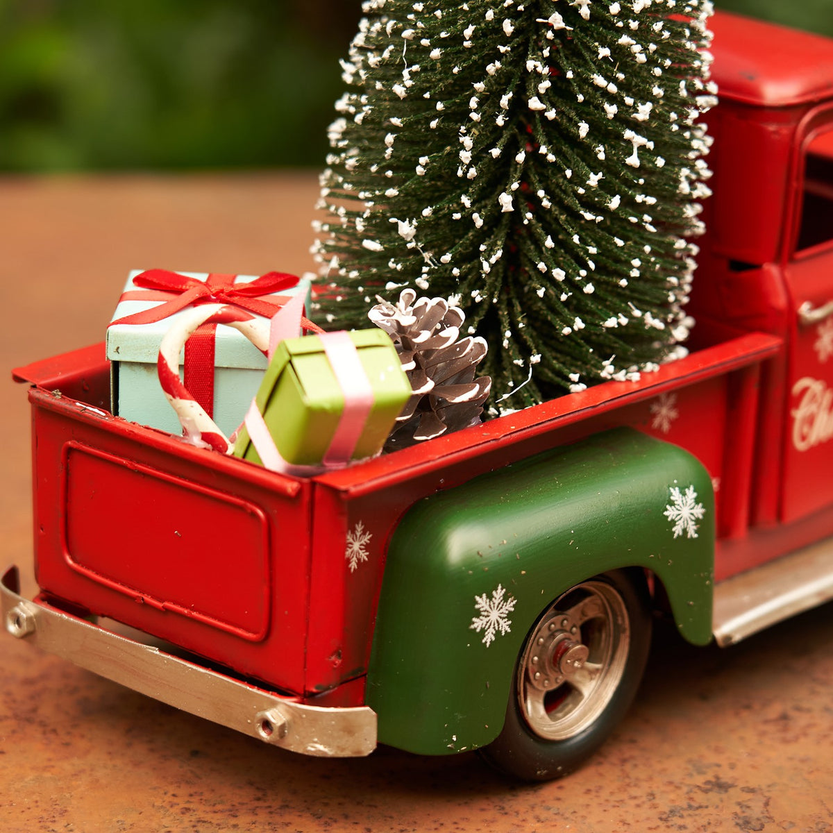 Close-up of the truck bed, green fender, snowflake details and miniature gifts
