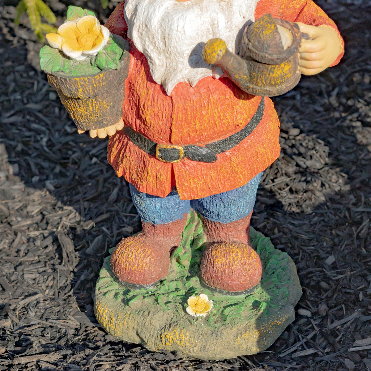 View of the gnome’s red coat, blue trousers, boots, and flower-dotted base.