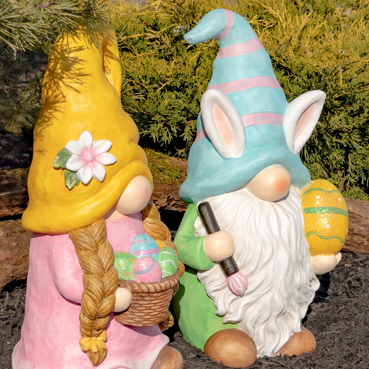 Two Easter garden gnomes shown together from an angled front view outdoors