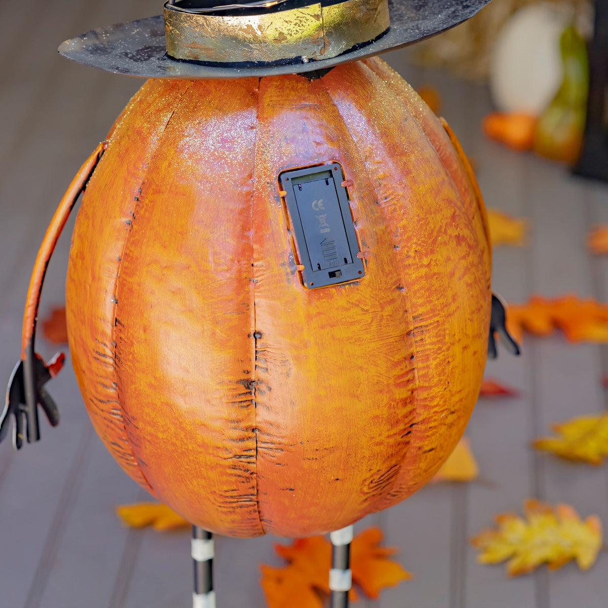 Back of the orange pumpkin figurine showing its battery compartment