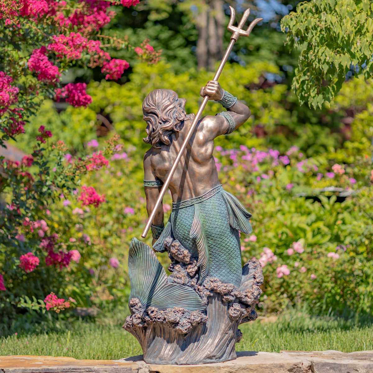 Back view of the merman holding a trident, showing his hair, tail and fin details.