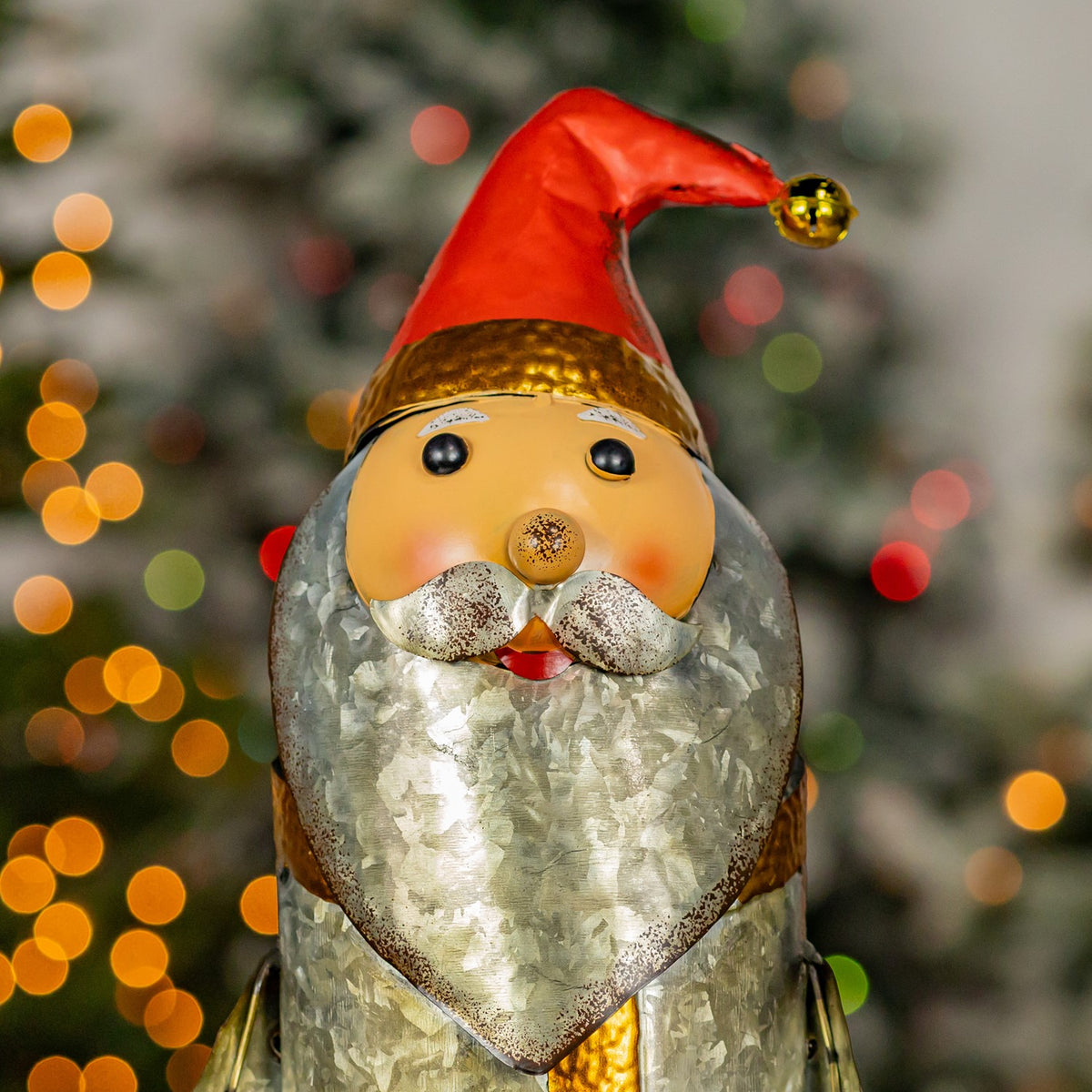 Close-up of Santa's face, silver beard, and red hat with gold bell